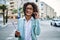 Young hispanic business woman wearing professional look smiling confident at the city holding worker clipboard