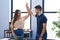 Young hispanic couple business workers high five with hands raised up working at office