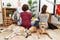 Young hispanic couple doing laundry with dogs standing backwards looking away with crossed arms