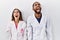 Young hispanic doctors standing over white background angry and mad screaming frustrated and furious, shouting with anger