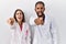 Young hispanic doctors standing over white background pointing displeased and frustrated to the camera, angry and furious with you