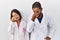 Young hispanic doctors standing over white background tired rubbing nose and eyes feeling fatigue and headache