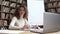 Young hispanic ethnic school math teacher sitting at workplace, portrait.