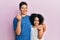 Young hispanic family of brother and sister wearing casual clothes together doing money gesture with hands, asking for salary