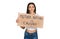 Young hispanic girl holding mother nature is crying protest cardboard banner covering mouth with hand, shocked and afraid for