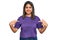 Young hispanic girl wearing casual purple t shirt looking confident with smile on face, pointing oneself with fingers proud and