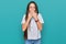 Young hispanic girl wearing casual white t shirt laughing and embarrassed giggle covering mouth with hands, gossip and scandal