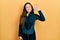 Young hispanic girl wearing diver neoprene uniform smiling positive doing ok sign with hand and fingers