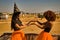 Young Hispanic and Latina women doing hand clapping games and dressed up for Halloween outdoors