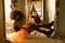 Young Hispanic and Latina women sitting on the floor in the hallway of a dilapidated building dressed for Halloween