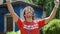 Young hispanic man activist wearing volunteer uniform doing winner gesture at park