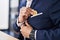 Young hispanic man business worker insert bitcoin on jacket at office