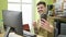 Young hispanic man business worker make selfie by smartphone at office