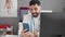 Young hispanic man doctor having video medical consultation at clinic