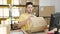 Young hispanic man ecommerce business worker scanning packages at office