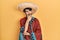 Young hispanic man holding mexican hat with hand on chin thinking about question, pensive expression