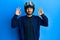 Young hispanic man holding motorcycle helmet relax and smiling with eyes closed doing meditation gesture with fingers