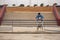 Young Hispanic man, leaning on a railing next to his dog in a funny attitude. Concept, dogs, pets, animals, friends