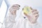 Young hispanic man scientist pouring liquid on sample at laboratory