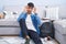 Young hispanic man sitting on the floor studying for university trying to open eyes with fingers, sleepy and tired for morning