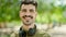 Young hispanic man smiling confident wearing headphones at park