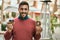 Young hispanic man smiling happy having breakfast at the city