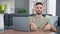 Young hispanic man taking glasses off doing online yoga exercise at home