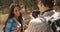 Young Hispanic man taking pictures of girl outdoors