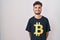 Young hispanic man with tattoos wearing bitcoin t shirt with a happy and cool smile on face