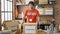 Young hispanic man volunteer holding donations cardboard box at charity center