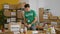 Young hispanic man volunteer holding products speaking at charity center