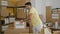 Young hispanic man volunteer packing donations cardboard box at charity center