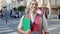 Young hispanic man volunteer smiling holding clipboard at street