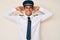 Young hispanic man wearing airplane pilot uniform relaxing and stretching, arms and hands behind head and neck smiling happy