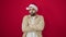 Young hispanic man wearing christmas hat standing with arms crossed gesture and unhappy expression over isolated red background