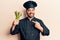 Young hispanic man wearing cooker uniform holding asparagus smiling happy pointing with hand and finger