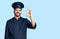 Young hispanic man wearing cooker uniform smiling positive doing ok sign with hand and fingers