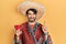 Young hispanic man wearing mexican hat holding chili surprised with an idea or question pointing finger with happy face, number