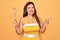 Young hispanic pin up woman wearing fashion sexy 50s style holding cooking whisk blender very happy pointing with hand and finger