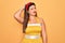 Young hispanic pin up woman wearing fashion sexy 50s style over yellow background confuse and wondering about question