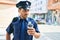 Young hispanic policeman wearing police uniform with serious expression