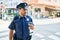 Young hispanic policeman wearing police uniform with serious expression