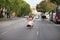 Young, Hispanic, pretty, brunette woman, wearing an elegant vintage violet dress, running funny on the road in the middle of