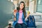 Young hispanic student girl smiling happy holding donut and green apple at the university