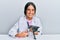 Young hispanic veterinary girl examining cat using stethoscope at the clinic