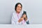 Young hispanic veterinary girl examining cat using stethoscope at the clinic