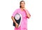 Young hispanic woman as nutritionist doctor holding weighing machine serious face thinking about question with hand on chin,