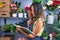 Young hispanic woman florist reading book at florist store