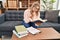 Young hispanic woman having psychology session reading book psychology center