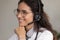 Young hispanic woman medical consultant wearing headphones taking patients calls